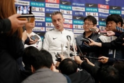 South Korean national soccer team head coach Paulo Bento answers a reporter's question upon his arrival after the soccer match against North Korea, at Incheon International Airport in Incheon, South Korea, Thursday, Oct. 17, 2019.