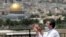 A muslim man prays in east Jerusalem's Mount of Olives, overlooking the Dome of the Rock and al-Aqsa mosque compound, which remains shut to prevent the spread of coronavirus during the holy month of Ramadan, May 22, 2020. 