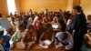 Children listen to a school teacher after the reopening of Mahamane Fondogoumo elementary school in the town center of Timbuktu, Mali, February 1, 2013.