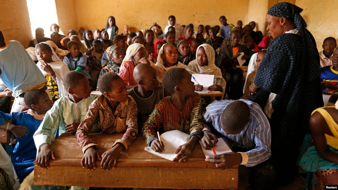 Children listen to a school teacher after the reopening of Mahamane Fondogoumo elementary school in the town center of Timbuktu, Mali, February 1, 2013.
