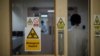 FILE - An employee walks through a door at a hospital in Nairobi, Kenya, April 24, 2020. Security is being increased at children's homes and hospitals in Kenya after three medical officers were charged Nov. 18, 2020, with child trafficking. 