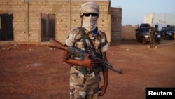 An ethnic Tuareg Malian soldier under the command of Col. El Hadj Ag Gamou stands guard at a checkpoint in Gao, Mali, March 3, 2013.