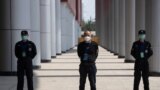 Security guards stand on duty at one of the temporary coronavirus hospitals during a visit by journalists in Wuhan, central China's Hubei province, April 9, 2020.