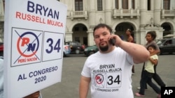 FILE - Bryan Russell takes a call as he campaigns for Congress in Lima, Peru, Dec. 13, 2019.