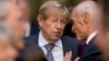 FILE - Former U.S. Solicitor General Ted Olson, center, speaks with former Homeland Security Secretary Michael Chertoff at the FBI Building in Washington, Sept. 28, 2017. Olson died on Wednesday. He was 84. 