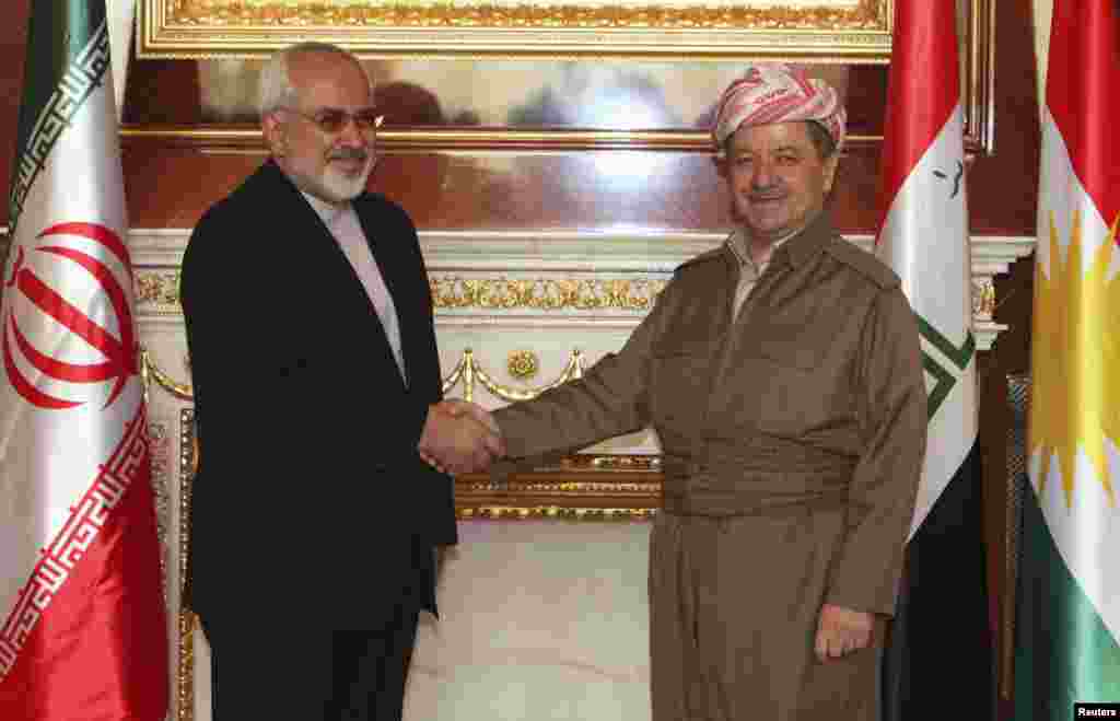 Iraqi Kurdish regional President Masoud Barzani (right) shakes hands with Iranian Foreign Minister Mohammad Javad Zarif in Irbil, north of Baghdad, Aug. 26, 2014.