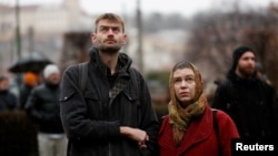 People observe a minute of silence commemorating the victims of a shooting at one of Charles University's buildings, in Prague, Czech Republic, on Dec. 23, 2023.