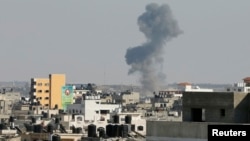 Smoke is seen after what witnesses said was an Israeli airstrike in Gaza City, Aug. 19, 2014. 
