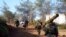 FILE - A rebel fighter carries an anti-tank weapon (R) as he heads with his fellow fighters towards their positions in the Armenian Christian town of Kasab, Apr. 23, 2014. 