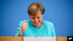 German Chancellor Angela Merkel reacts as she holds her annual summer news conference in Berlin, Germany, July 22, 2021. 