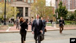 Members of the defense team for Paul Manafort, Kevin Downing, center, and Thomas Zehnle, center right, depart the federal court following a hearing in the criminal case against former Trump campaign chairman Paul Manafort in Alexandria, Va., Friday, Oct. 19, 2018. 