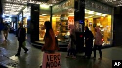 People walk in front of a shop in Hamra street in Beirut, Lebanon, Nov. 10, 2017. Things were looking up for the Lebanese economy until Prime Minister Saad Hariri resigned.