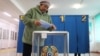 A woman casts her vote during a referendum on the construction of a nuclear power plant, at a polling station in the village of Ulken in the Almaty Region, Kazakhstan, Oct. 6, 2024. 