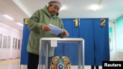 A woman casts her vote during a referendum on the construction of a nuclear power plant, at a polling station in the village of Ulken in the Almaty Region, Kazakhstan, Oct. 6, 2024. 