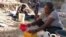 A woman mixes Clorox with water to drink in Port-au-Prince, Haiti, on April 3, 2020. Some Haitians believe the mixture can prevent them from COVID-19 infection.