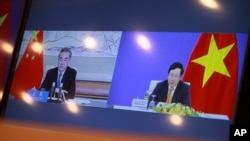 A TV screen shows Vietnamese Foreign Minister Pham Binh Minh and his Chinese counterpart Wang Yi during a virtual meeting on bilateral issues, in Hanoi, Vietnam, July 21, 2020.