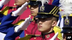 FILE - South Korean cadets salute South Korean President Kim Dae-jung during a graduation ceremony of the 58th military academy of South Korea, at the Hwarang drill field in Seoul.