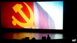 The state-backed documentary film "Amazing China" shows the Communist party flag and subtitles in Chinese "In the wind and rain, the voyage is magnificent" at the Beijing Film Academy in Beijing, China, March 22, 2018.