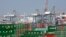 FILE - Cargo containers sit idle at the Port of Los Angeles as a back-log of over 30 container ships sit anchored outside the Port in Los Angeles, California, February 18, 2015.