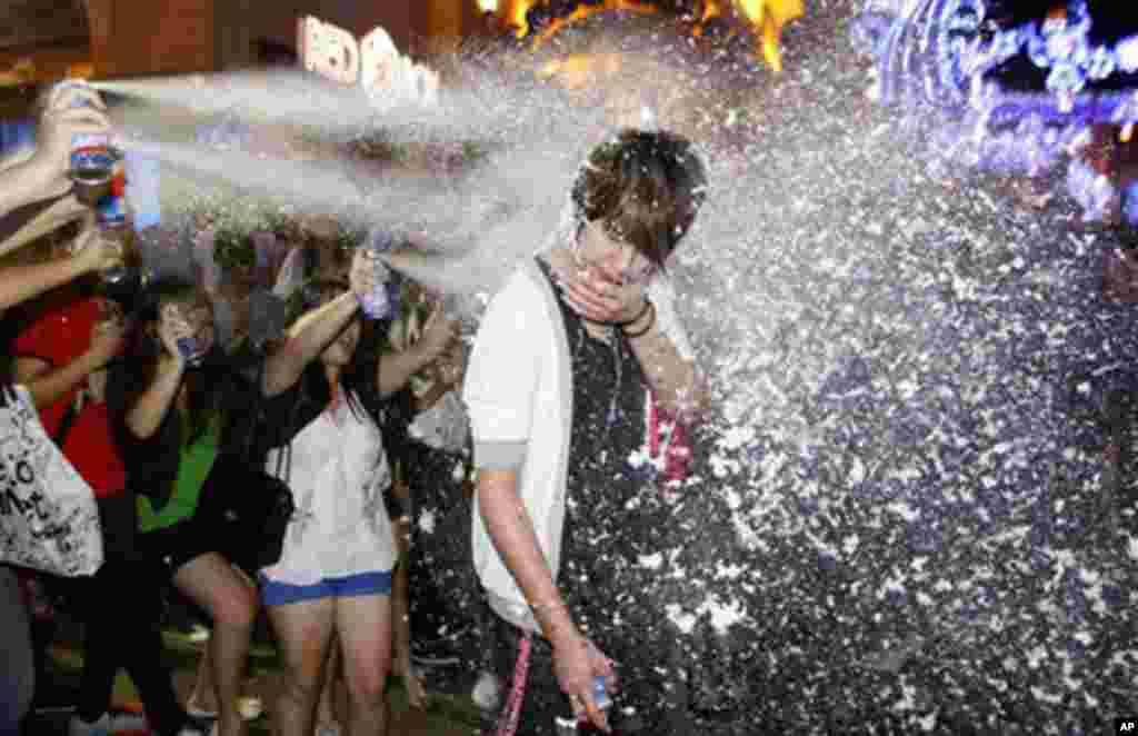 A man is sprayed by artificial snow during New Year's Eve celebrations in Petaling Jaya, near Kuala Lumpur, Malaysia, 31 Dec 2010. (AP Image)