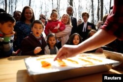 FILE - New Canadian citizen David Alfonso, 8, reacts as maple taffy is prepared for new Canadians following a citizenship ceremony at the Vanier Sugar Shack in Ottawa, Ontario, Canada, April 11, 2018.