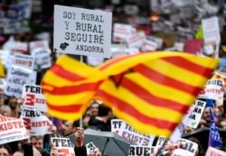 FILE -  A man holds a placard reading 'I am rural and will always be' during a demonstration to protest against the lack of infrastructures in depopulated areas of Spain´s rural interior, on March 31, 2019 in Madrid.