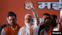 India's Prime Minister Narendra Modi waves toward his supporters during an election campaign rally in New Delhi, May 8, 2019.