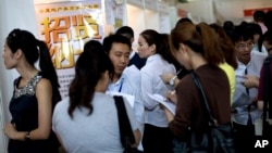 FILE - Chinese job seekers visit a job fair held at the China International Exhibition Center in Beijing. 