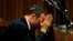 Oscar Pistorius reacts in the dock ahead of his trial for the murder of girlfriend Reeva Steenkamp, North Gauteng High Court, Pretoria, March 5, 2014.