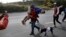 Migrant Darwin Leonel Carcamo is carried by a fellow migrant, part of the caravan hoping to reach the U.S. border, after he fell off a truck and broke his leg, on the road that connects Irapuato with Guadalajara, Mexico, Nov.12, 2018. 