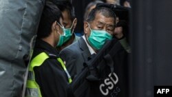 (FILES) Jimmy Lai is escorted into a Correctional Services van in Hong Kong.