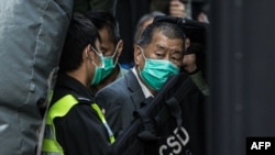 FILE - Pro-democracy media tycoon Jimmy Lai is escorted into a Correctional Services van outside the Court of Final Appeal in Hong Kong on Feb. 1, 2021.