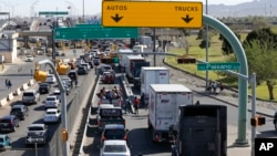 Cars and trucks line up to enter Mexico from the U.S. at a border crossing in El Paso, Texas, March 29, 2019. 