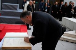 U.S. Secretary of State Mike Pompeo signs a guest book during a memorial service marking the death of 85 people who died in a 1994 bombing blamed on Hezbollah, in Buenos Aires, Argentina, July 19, 2019.