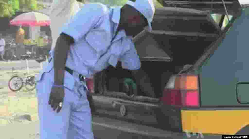 A car is searched at a Civilian JTF check-point in Maiduguri, Nigeria, December 2013. (Heather Murdock for VOA)