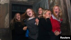 FILE - A group of girls scream in a haunted house in Denver, Colorado, October 2013. 