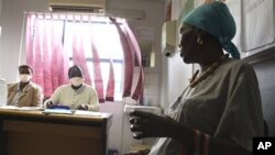 Pinky Molefe, right, gets TB medication at a clinic in Alexandra township, north of Johannesburg, 13 Oct 2010