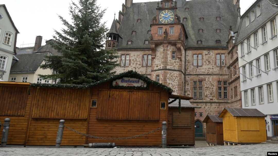A view of closed booths of a Christmas market that will open its doors in the upcoming days, in front of the townhall in Marburg, Germany, Nov. 17, 2021.