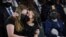 Abigail Evans, 7, and Logan Evans, 9, the children of the late Capitol Police officer William "Billy" Evans, sit with their mother Shannon Terranova, left, during a memorial service as Evans lies in honor in the Rotunda at the U.S. Capitol in Washington.