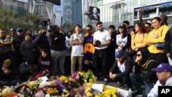 People gather at a memorial for Kobe Bryant near Staples Center, Jan. 26, 2020, in Los Angeles.