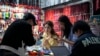 Merchants film their jewelry products for e-commerce sales at their store inside the Yiwu wholesale market in Yiwu, east China's Zhejiang province Friday, Nov. 8, 2024.