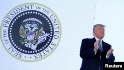 FILE - U.S. President Donald Trump takes the stage next to an altered presidential seal prior to a speech at Turning Point USA's Teen Student Action Summit in Washington, July 23, 2019. 