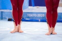 FILE - German gymnasts wear unitards and wait to perform during the women's artistic gymnastic qualifications at the 2020 Summer Olympics, in Tokyo, July 25, 2021.