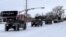 Military vehicles from the Texas Military Department of the Texas National Guard, tasked to transport residents to designated warming centers and other required duties, form a convoy in Abilene, Texas, U.S. February 16, 2021. Greg Jaklewicz/Reporter-News/