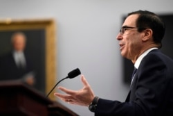 FILE - Treasury Secretary Steven Mnuchin testifies on Capitol Hill in Washington, March 11, 2020, before a House Appropriations subcommittee hearing on the FY'21 budget.