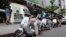 In this Monday, June 15, 2015, photo, Gogoro electric scooters are test driven by potential customers outside a showroom in Taipei, Taiwan.