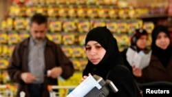 Syrian refugees shop after they receiving humanitarian aid shopping vouchers at a mall in Amman, April 11, 2013.