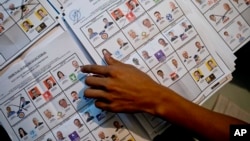 An electoral worker counts ballots at a polling station in Guatemala City, Sunday, Sept. 6, 2015. 