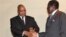 South African President Jacob Zuma and President Robert Mugabe, right, shake hands after discussions in Harare, March 18, 2010.