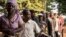 FILE - Voters queue outside a polling station in Bangui on Dec. 13, 2015, to vote for the constitutional referendum, seen as a test run for presidential and parliamentary polls.
